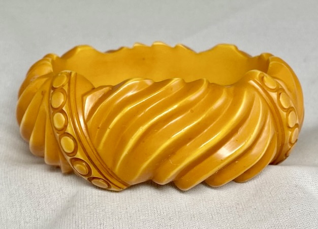 BB378 butterscotch wave and circle carved bakelite bangle